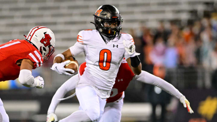 Nick Abrams of McDonogh (0) runs for extra yardage in the 2023 MIAA A Conference championship game against Archbishop Spalding.