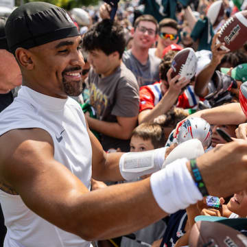 Eagles QB Jalen Hurts signs autographs after Tuesday's practice in New England.