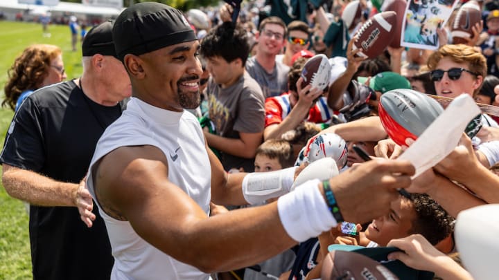 Eagles QB Jalen Hurts signs autographs after Tuesday's practice in New England.