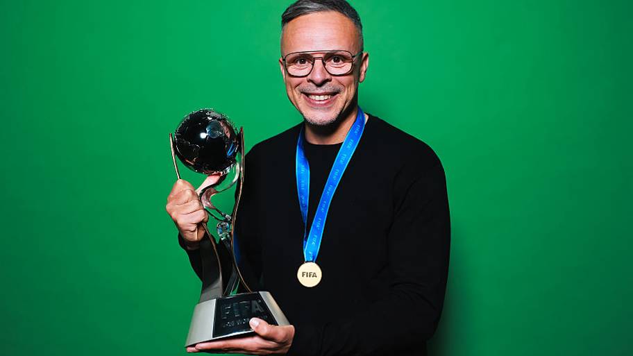 Mohamed Ouahbi hold the FIFA U-20 World Cup trophy.
