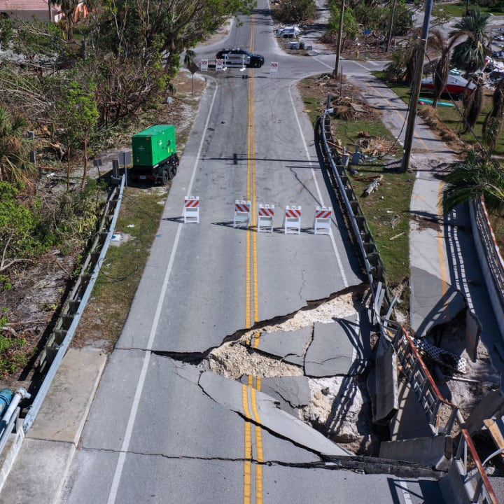A damaged road following Hurricane Ian