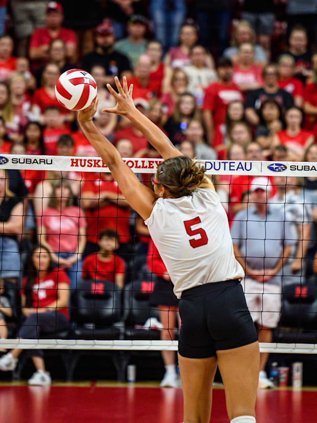 Rebekah Allick blocks a kill from the alums. 