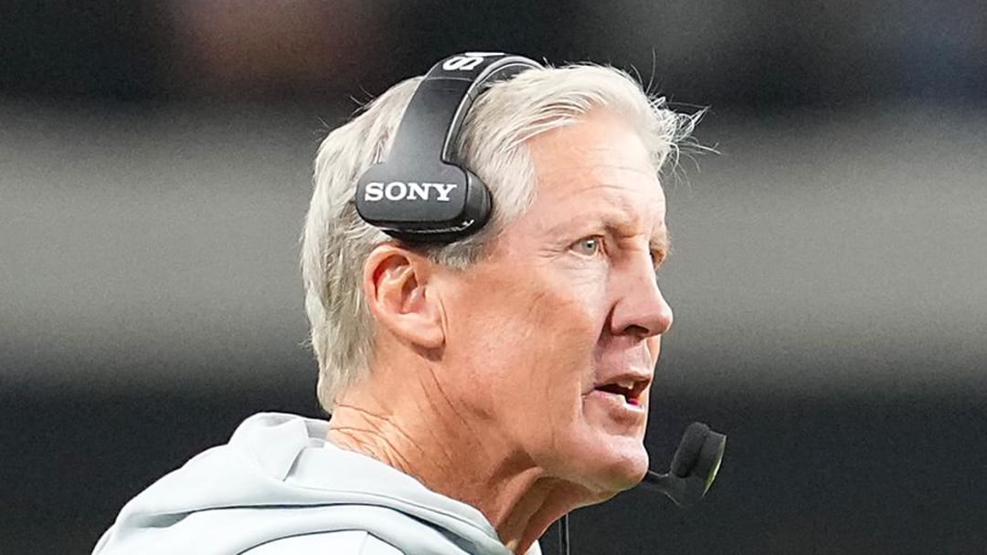 Nov 23, 2025; Paradise, Nevada, USA; Las Vegas Raiders quarterback Geno Smith (7) talks to head coach Pete Carroll in game against the Cleveland Browns during the fourth quarter at Allegiant Stadium. Mandatory Credit: Stephen R. Sylvanie-Imagn Images