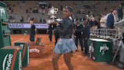 Coco Gauff takes a video with her trophy after winning the French Open.