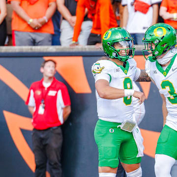 Oregon Ducks quarterback Dillon Gabriel and tight end terrance ferguson celebrate in the win over the Oregon State Beavers