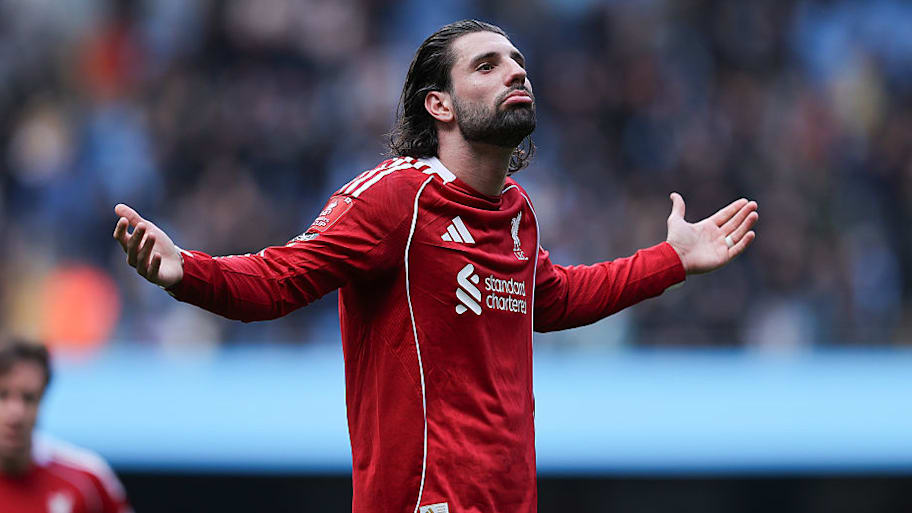 Dominik Szoboszlai gesturing to Liverpool supporters. 