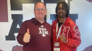 Hitchcock High School receiver Kelshaun Johnson poses with Texas A&M Aggies coach Mike Elko during a recruitment visit.
