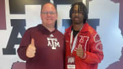 Hitchcock High School receiver Kelshaun Johnson poses with Texas A&M Aggies coach Mike Elko during a recruitment visit.