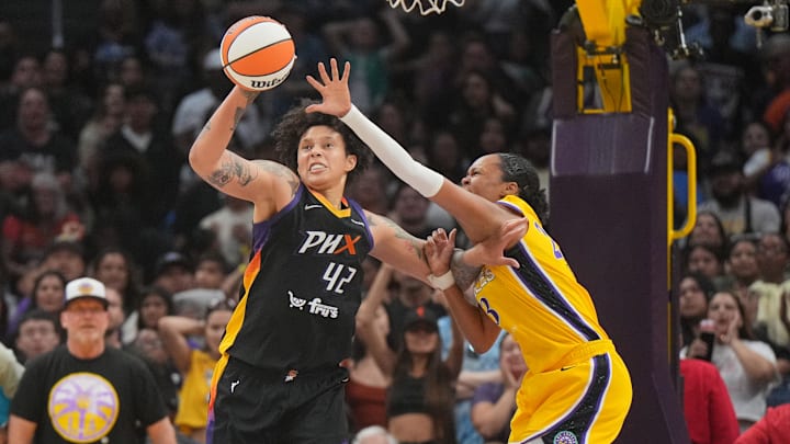 Jul 7, 2024; Los Angeles, California, USA; Phoenix Mercury center Brittney Griner (42) and LA Sparks forward Azura Stevens (23) battle for the ball in the second half at Crypto.com Arena. Mandatory Credit: Kirby Lee-Imagn Images