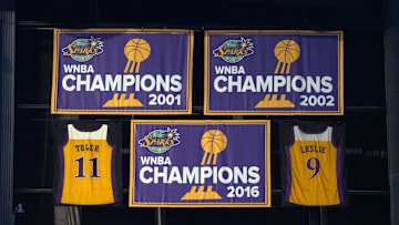 Jul 7, 2024; Los Angeles, California, USA; The LA Sparks 2001, 2002 and 2016 WNBA Championship banners and retired jerseys of Penny Toler (9) and Lisa Leslie (11) at Crypto.com Arena. Mandatory Credit: Kirby Lee-Imagn Images