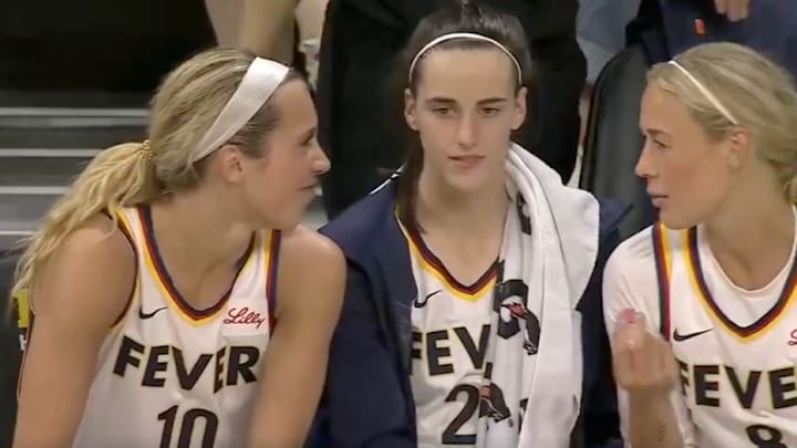 Indiana Fever players Lexie Hull, Caitlin Clark and Sophie Cunningham sit on the bench at Carver-Hawkeye Arena. 