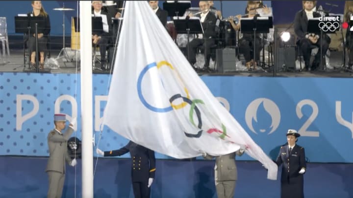Olympic flag is raised during the opening ceremony of the 2024 Games in Paris.