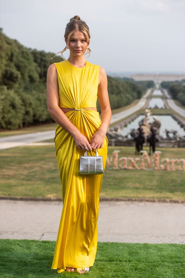 Ellie Thumann wears a yellow gown in Caserta, Italy.