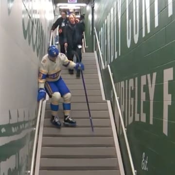 Alexey Toropchenko struggles to walk down the stairs with his skates on at the 2024 Winter Classic.