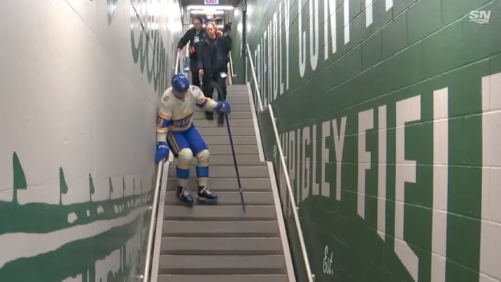 Alexey Toropchenko struggles to walk down the stairs with his skates on at the 2024 Winter Classic.