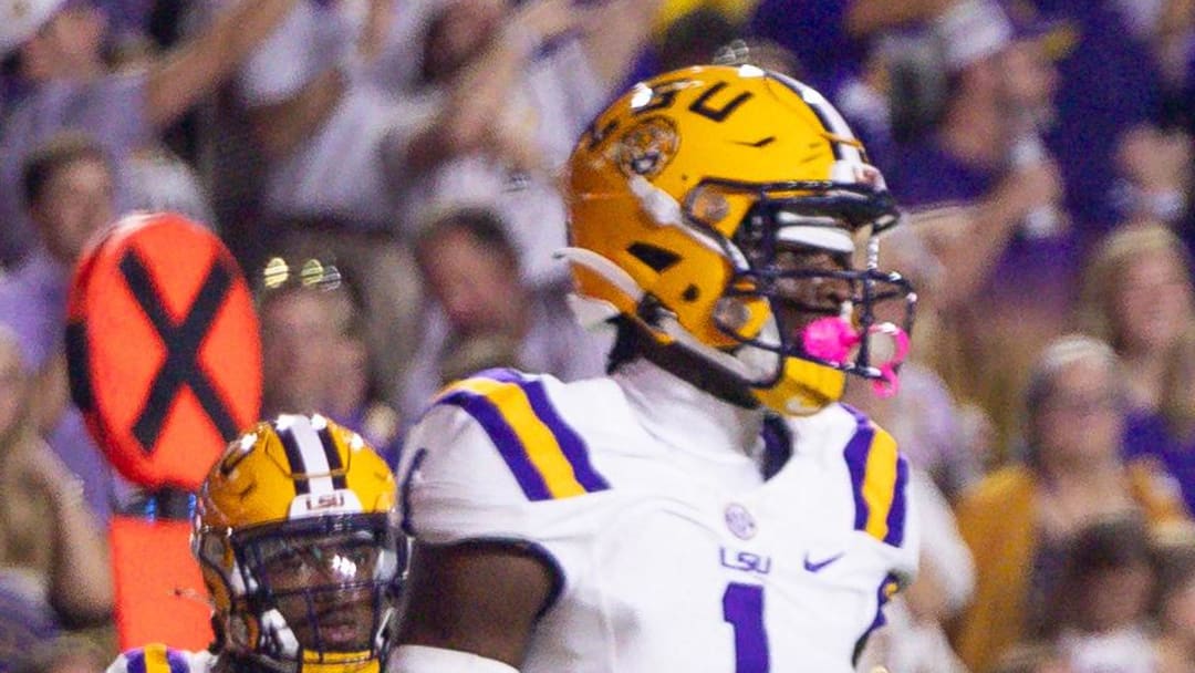 Oct 12, 2024; Baton Rouge, Louisiana, USA;  Mississippi Rebels quarterback Jaxson Dart (2) scrambles for a first down against LSU Tigers cornerback Ashton Stamps (1) during the first half at Tiger Stadium. Mandatory Credit: Stephen Lew-Imagn Images