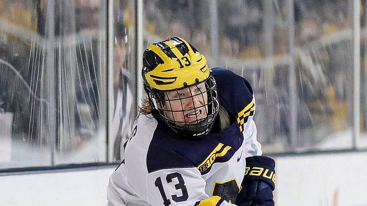 Michigan center TJ Hughes makes a pass against Michigan State defenseman Nash Nienhuis during the third period at Yost Ice Arena in Ann Arbor on Friday, Feb. 9, 2024.