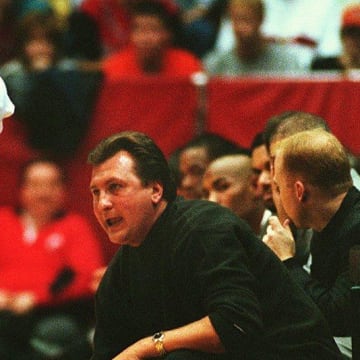 NOVEMBER 16, 1999: UC head basketball coach Bob Huggins talks with Steve Logan on the sideline.