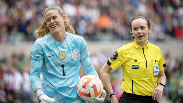 U.S. goalkeeper Alyssa Naeher smiles after a referee makes a call during an international soccer match.