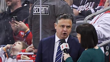 New Jersey Devils interim head coach Travis Green talks with ESPN reporter Leah Hextall during the first period of the NHL against the St. Louis Blues at Prudential Center on March 7, 2024.