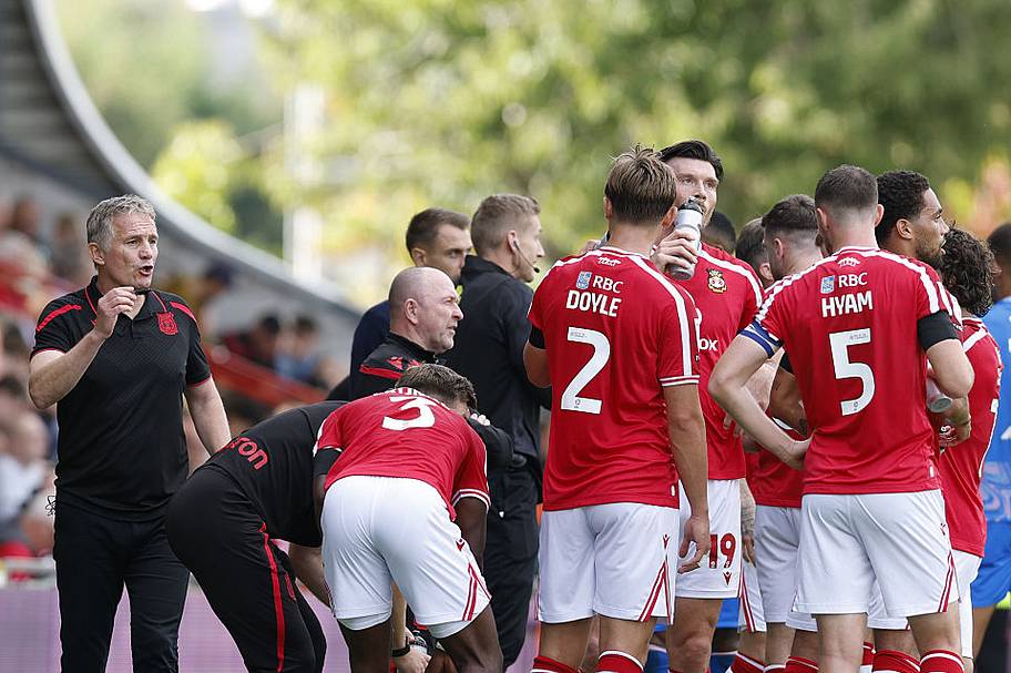 Wrexham manager Phil Parkinson speaks to his players during the Sky Bet Championship match at The Racecourse Ground.