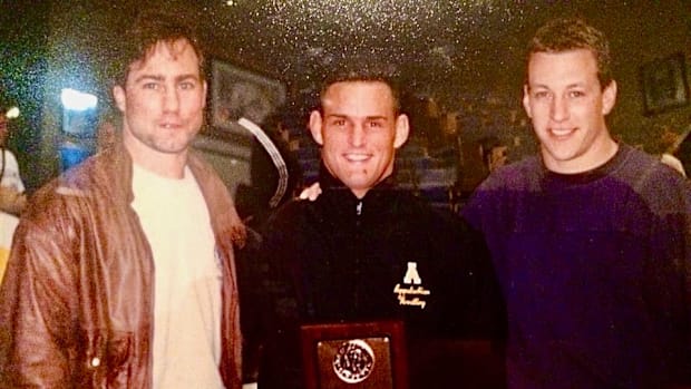 Victor Balmeceda (center) won the Southern Conference wrestling title and the Outstanding Wrestler Award .