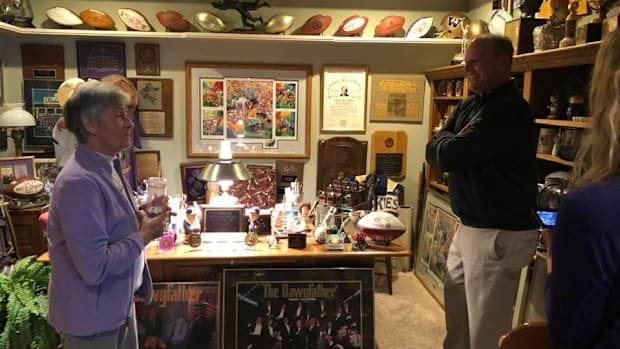 Carol James shows then Husky coach Kalen DeBoer her husband's office. 