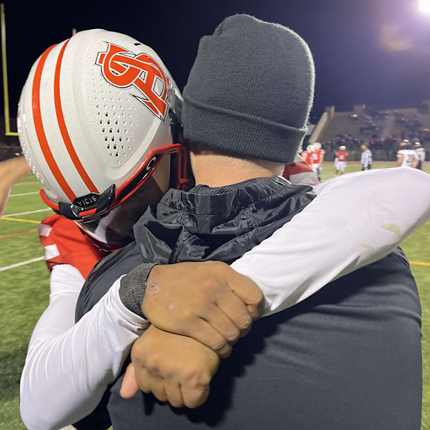 Malik Washington and Archbishop Spalding coach Kyle Schmitt hug.