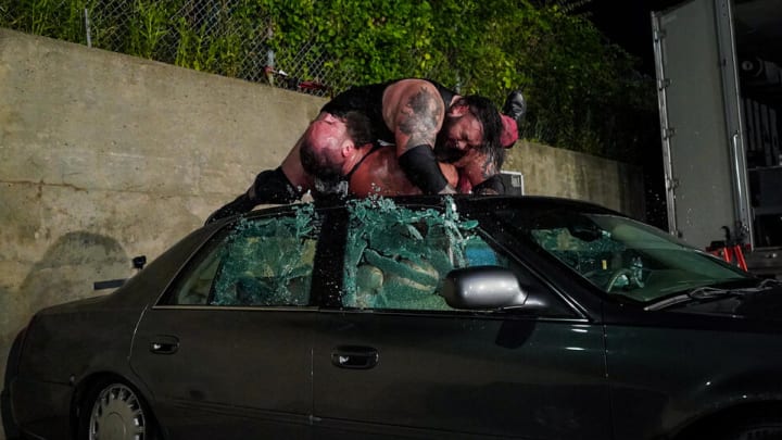 Bronson Reed crushes Braun Strowman on the roof of a car.