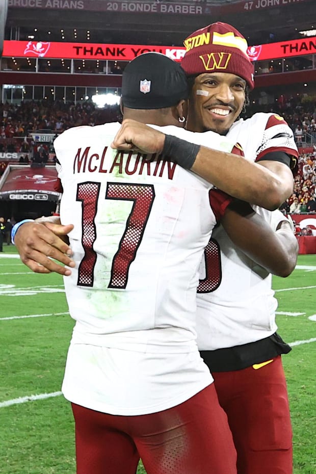 Washington Commanders quarterback Jayden Daniels celebrates with wide receiver Terry McLaurin