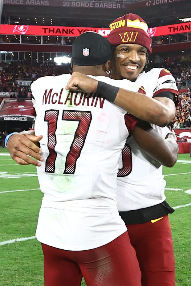Washington Commanders quarterback Jayden Daniels celebrates with wide receiver Terry McLaurin.