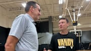 Perdue chats with Vanderbilt head coach Mark Byington at a practice.