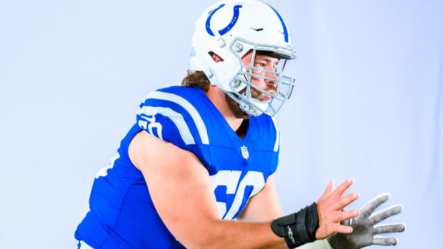 Colts offensive guard Tanor Bortolini (blue jersey with white helmet) practices his pass-blocking techniques. 