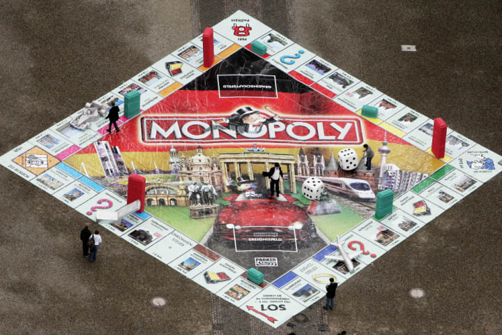 A giant Monopoly game is displayed in th