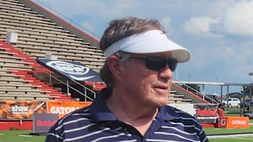 Bill Belichick, left, talks with Peyton Manning, right, at the 2024 Manning Passing Academy.