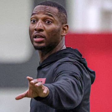 Arkansas Razorbacks secondary coach Nick Perry during preseason camp drills Tuesday at the indoor practice center in Fayetteville, Ark.