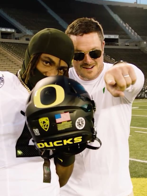 Oregon Ducks recruiting target Dallas Wilson and coach Dan Lanning in Autzen Stadium.
