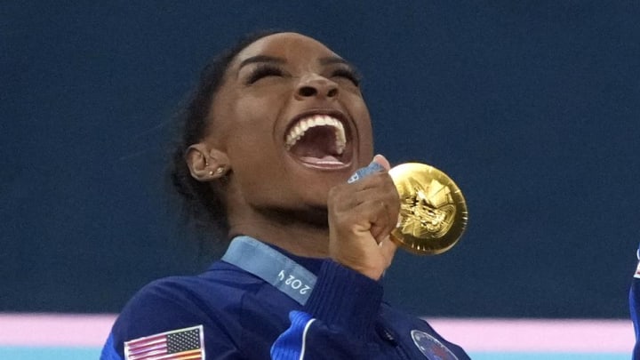 Jul 30, 2024; Paris, France; Simone Biles of the United States celebrates with her gold medal after the women’s team final at the Paris 2024 Olympic Summer Games at Bercy Arena. Mandatory Credit: Jack Gruber-USA TODAY Sports