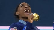 Jul 30, 2024; Paris, France; Simone Biles of the United States celebrates with her gold medal after the women’s team final at the Paris 2024 Olympic Summer Games at Bercy Arena. 