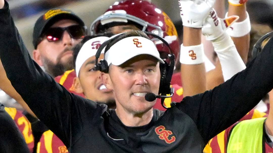 USC Trojans head coach Lincoln Riley and defensive line coach Shaun Nua celebrate on the sideline. 