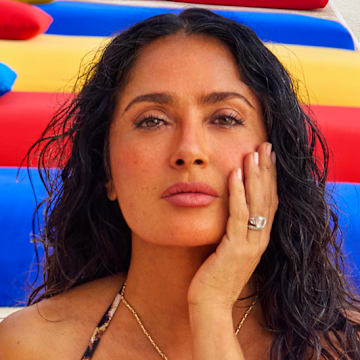 Salma Hayek Pinault was photographed by Ruven Afanador in Mexico. Swimsuit by Sommer Swim. Necklace by Jacquie Aiche.