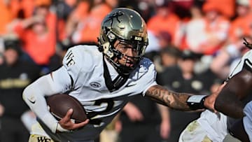 Oct 4, 2025; Blacksburg, Virginia, USA; Wake Forest Demon Deacons quarterback Robby Ashford (2) looks to run the ball against the Virginia Tech Hokies during the fourth quarter at Lane Stadium. Mandatory Credit: Brian Bishop-Imagn Images