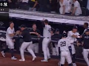 New York Yankees players celebrate in the dugout after Aaron Judge's go-ahead grand slam in the bottom of the seventh inning of Friday's win over the Boston Red Sox. 