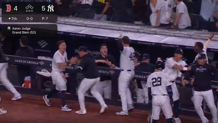 New York Yankees players celebrate in the dugout after Aaron Judge's go-ahead grand slam in the bottom of the seventh inning of Friday's win over the Boston Red Sox. 