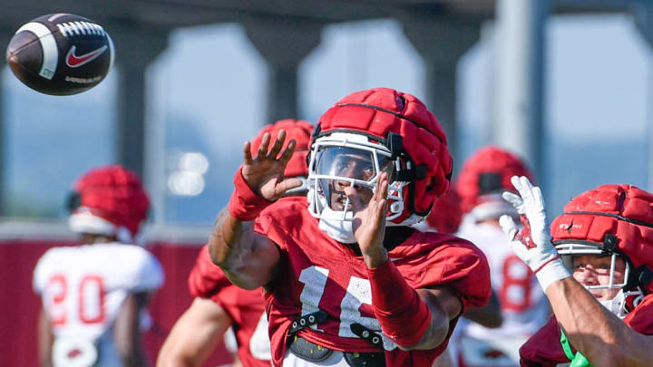 Arkansas Razorbacks defensive back Jaheim Singletary (15) goes for a pass against Landon Phipps in Monday's practice in Fayetteville, Ark.