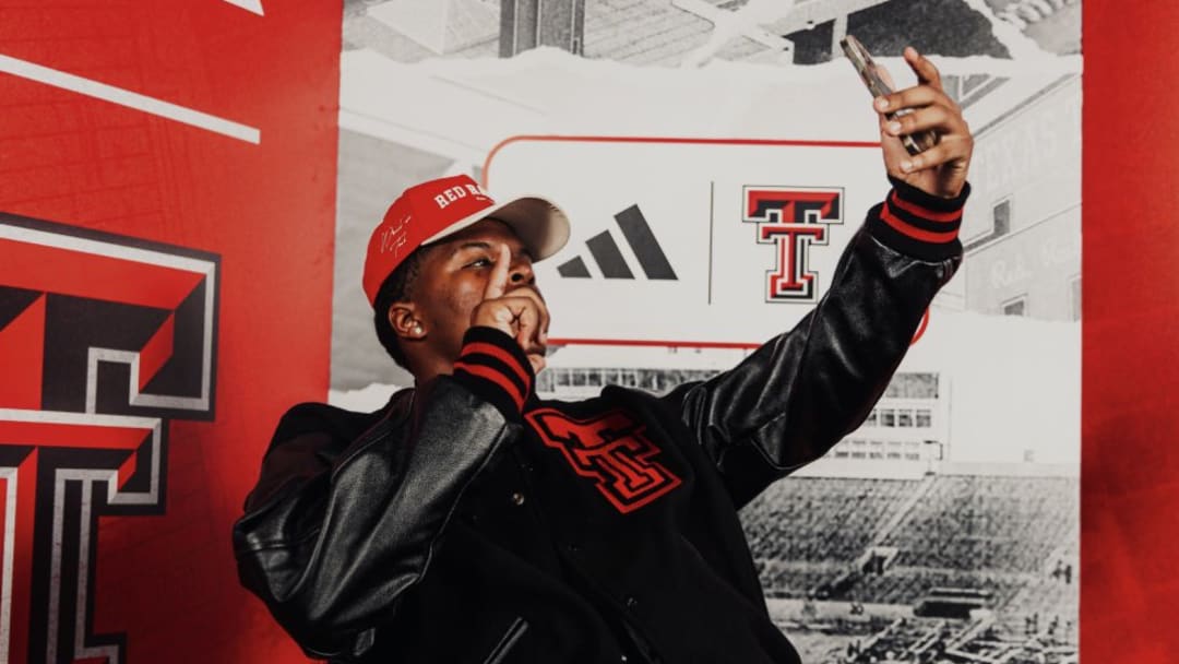 Kaleb Burns poses in Texas Tech gear on a visit to the school. The 3-star linebacker committed to Texas Tech on Monday.