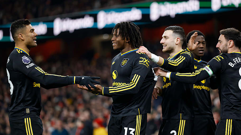 Man Utd players celebrate a Patrick Dorgu goal vs. Arsenal.