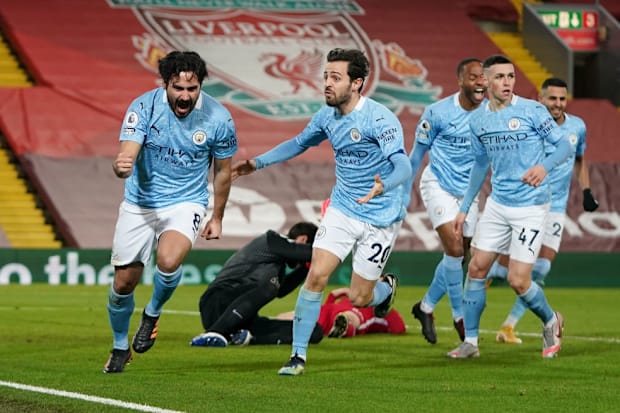 Manchester City players celebrate at Anfield
