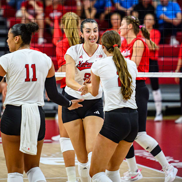 Virginia Adriano (9) celebrates with Bergen Reilly after a kill. 