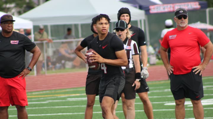 Corona Centennial QB Husan Longstreet while head coach Matt Logan (red shirt) watches.